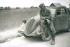 German soldier and his Italian-built Fiat 500 marked with the double cross insignia of Panzer ...jpg