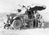 Officers_of_the_11th_Hussars_in_a_Morris_CS9_armoured_car_use_a_parasol_to_give_shade_while_ou...jpg